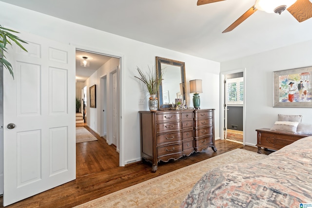 bedroom featuring wood finished floors, baseboards, and ceiling fan