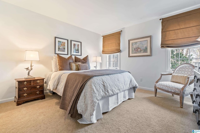 bedroom with baseboards, multiple windows, and carpet floors