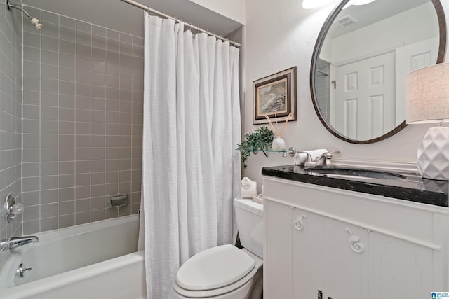 bathroom with visible vents, toilet, vanity, and shower / bath combination with curtain