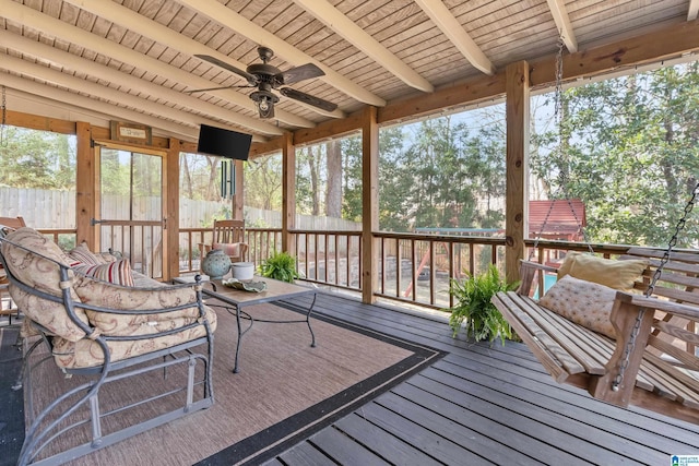 unfurnished sunroom with wood ceiling, vaulted ceiling with beams, and a ceiling fan