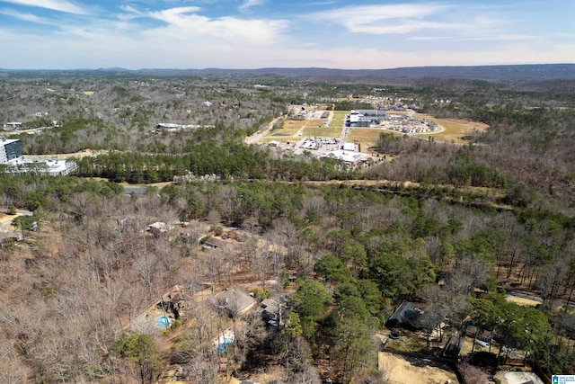 bird's eye view featuring a wooded view