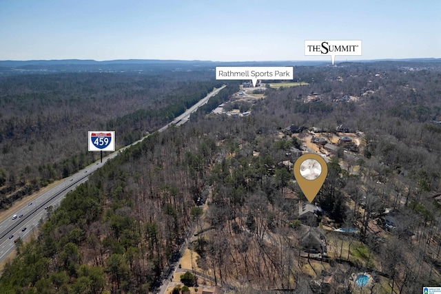 drone / aerial view featuring a view of trees