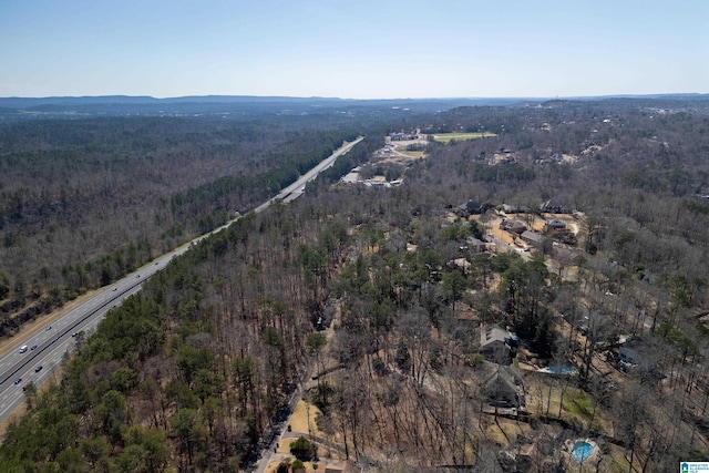 bird's eye view featuring a wooded view