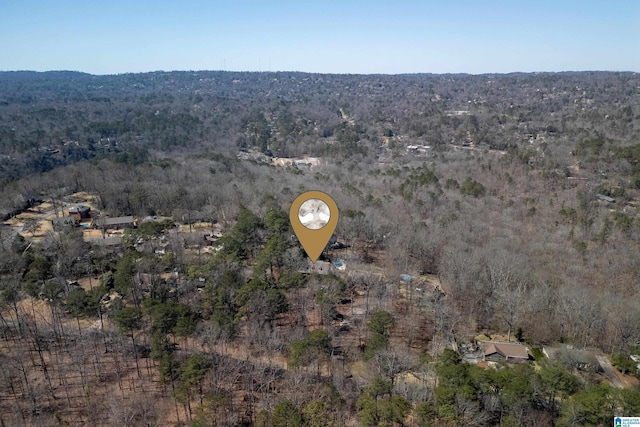 bird's eye view featuring a wooded view