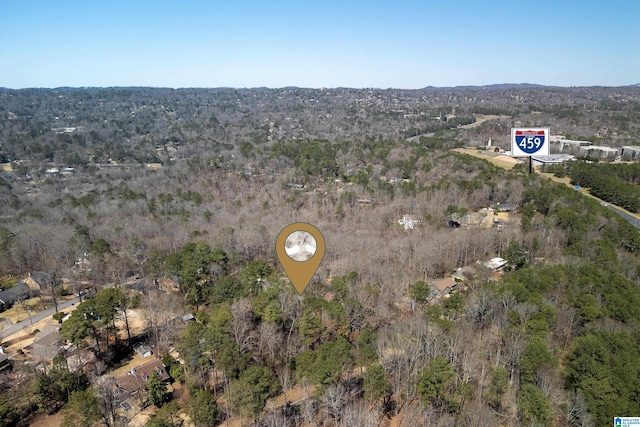 birds eye view of property with a view of trees