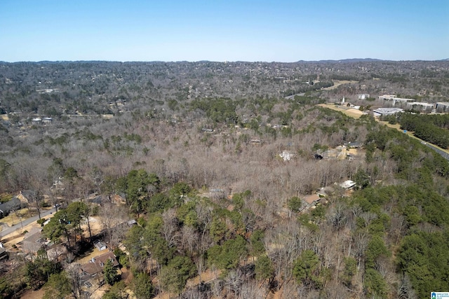 drone / aerial view with a wooded view