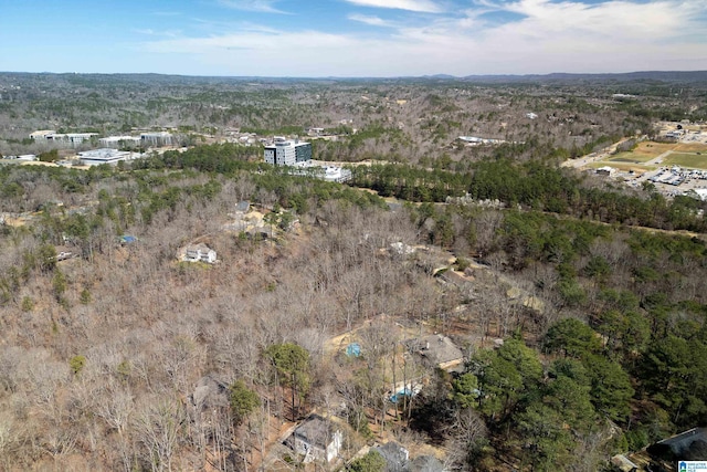 bird's eye view featuring a wooded view