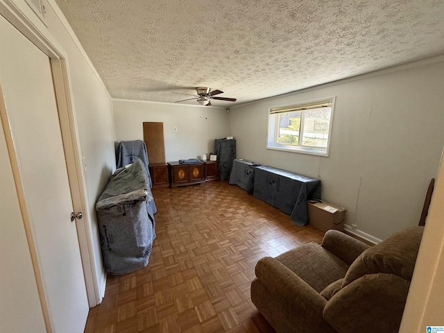 interior space with a textured ceiling and ceiling fan