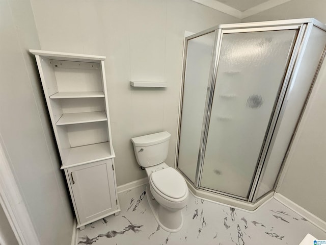 bathroom featuring marble finish floor, a stall shower, toilet, and baseboards