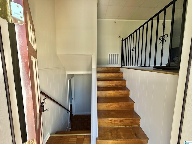 staircase featuring visible vents