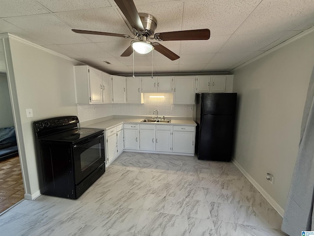 kitchen with black appliances, a sink, tasteful backsplash, white cabinetry, and light countertops