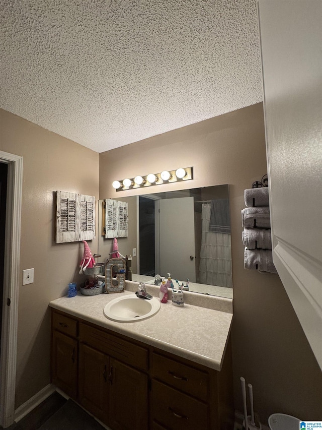 full bathroom with vanity and a textured ceiling