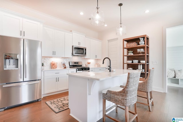 kitchen with stainless steel appliances, white cabinetry, tasteful backsplash, and light wood finished floors