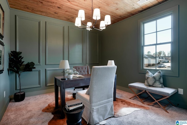 office with a decorative wall, a notable chandelier, wooden ceiling, and carpet