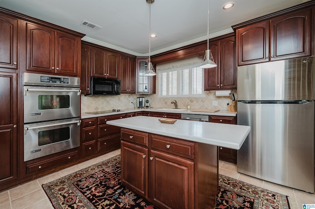 kitchen featuring backsplash, decorative light fixtures, light countertops, light tile patterned floors, and black appliances