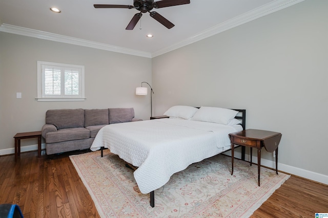 bedroom with recessed lighting, crown molding, baseboards, and wood finished floors