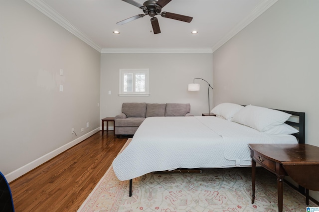 bedroom featuring crown molding, recessed lighting, wood finished floors, and baseboards