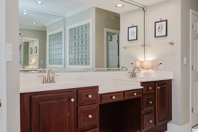 full bathroom with double vanity, crown molding, and a sink