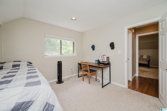 carpeted bedroom featuring recessed lighting, a textured ceiling, baseboards, and vaulted ceiling