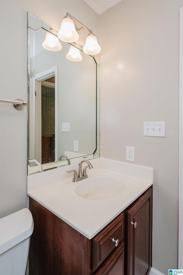 bathroom featuring toilet and vanity