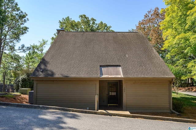 view of front of home featuring roof with shingles