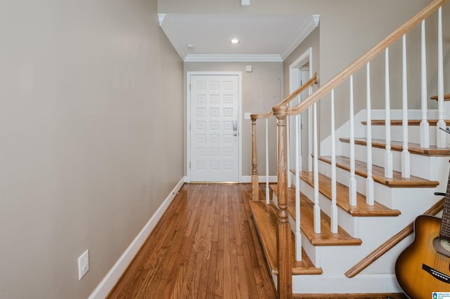 interior space with crown molding, recessed lighting, wood finished floors, and baseboards