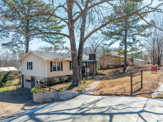 single story home featuring an attached garage, a chimney, driveway, and fence