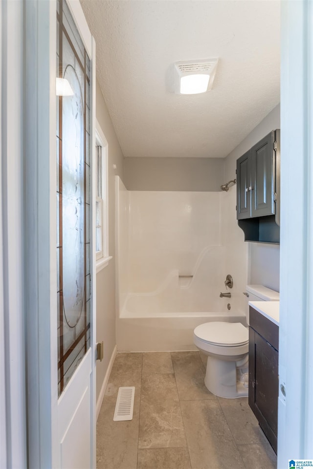 bathroom featuring visible vents, baseboards, toilet, bathtub / shower combination, and vanity