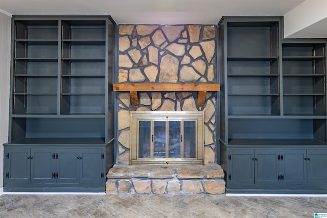 interior details with built in features and a stone fireplace