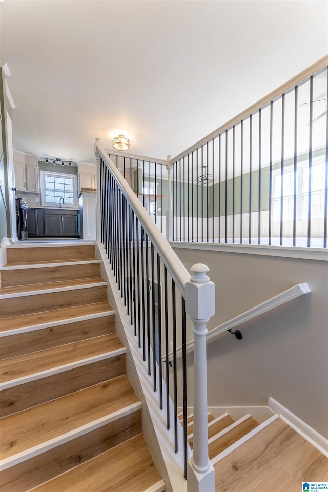 stairway with wood finished floors