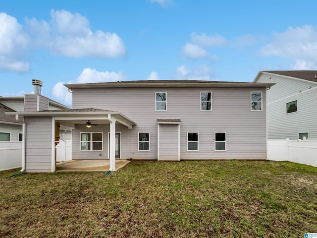 rear view of property with a patio area, a lawn, a ceiling fan, and fence