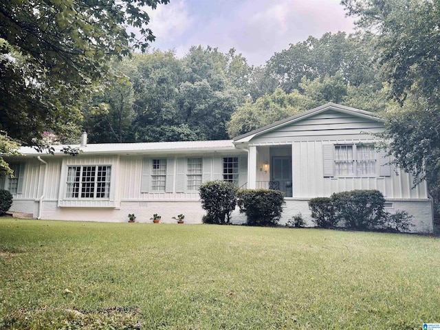 ranch-style home with brick siding and a front lawn