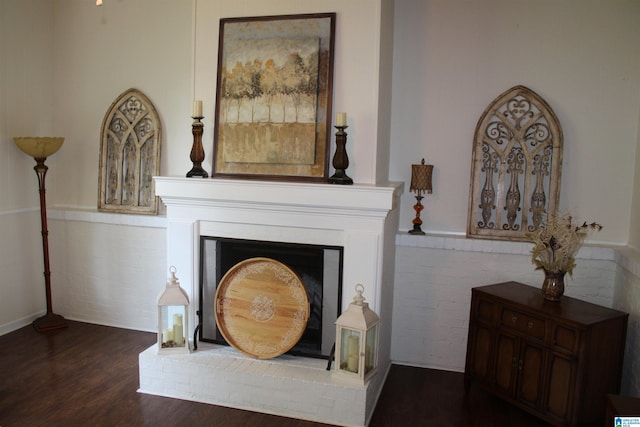 room details with a brick fireplace and wood finished floors