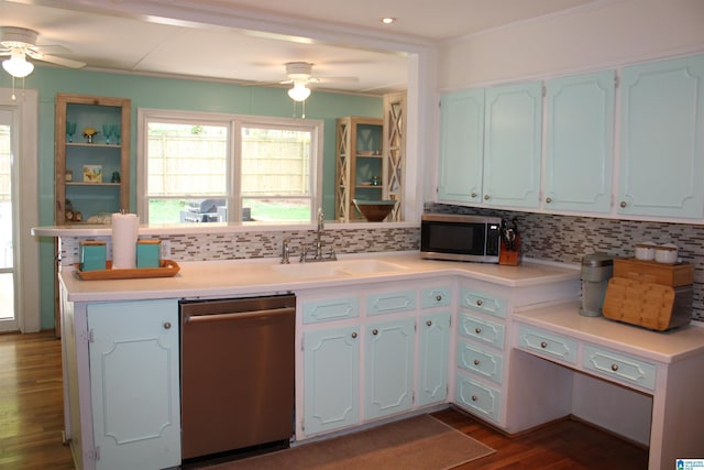 kitchen featuring a sink, wood finished floors, tasteful backsplash, and stainless steel appliances