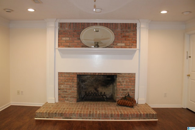 room details with a brick fireplace, wood finished floors, baseboards, and ornamental molding