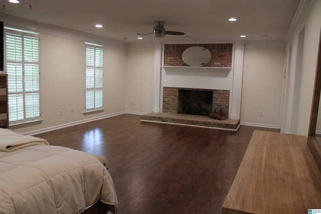 living area featuring a ceiling fan, wood finished floors, recessed lighting, baseboards, and a brick fireplace