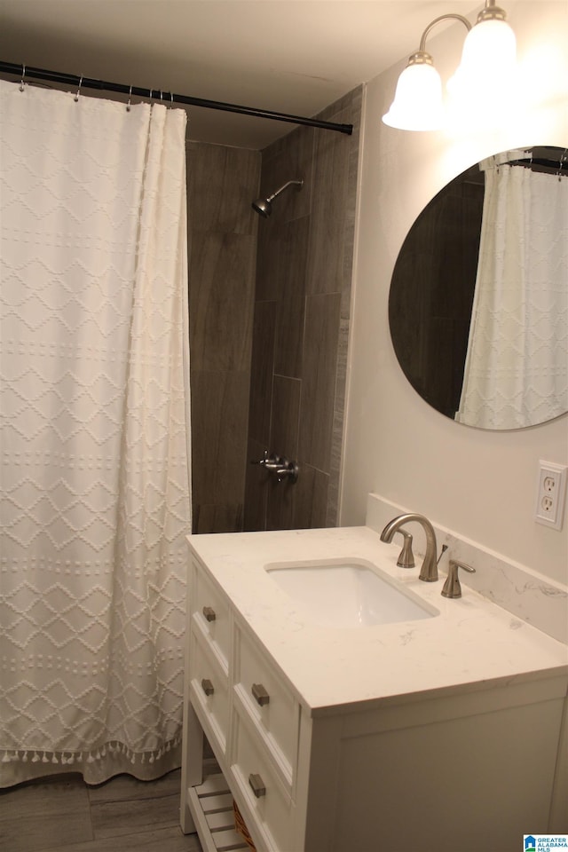 full bath with vanity, a shower with curtain, and wood finished floors