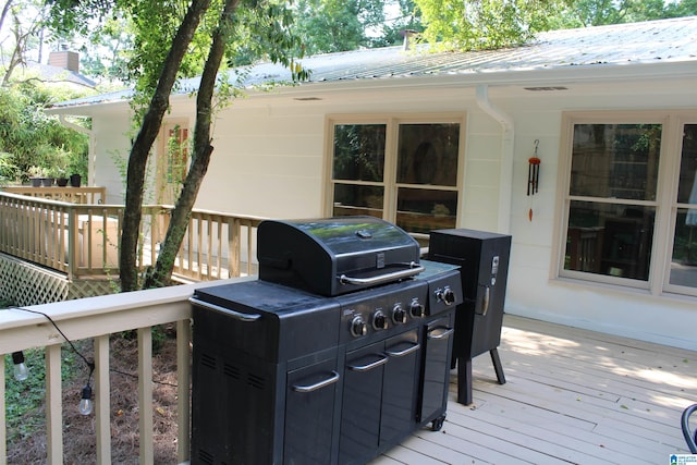 wooden deck with a grill