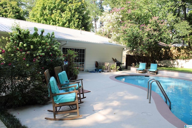 view of pool with a patio area, a fenced in pool, and fence