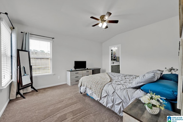 carpeted bedroom featuring baseboards, lofted ceiling, and a ceiling fan