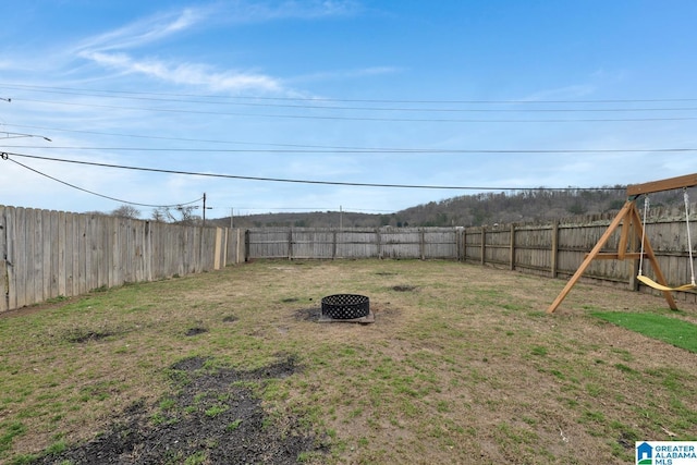 view of yard featuring a fenced backyard and an outdoor fire pit