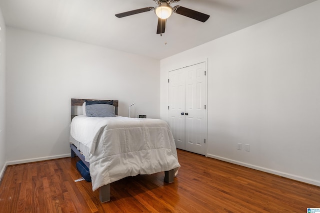 bedroom featuring ceiling fan, baseboards, and wood finished floors