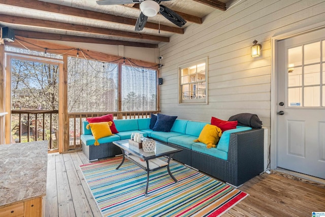 sunroom with beamed ceiling and a ceiling fan