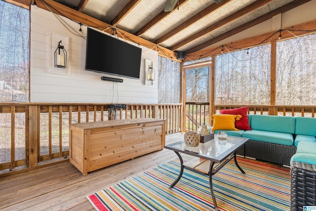 sunroom with vaulted ceiling with beams