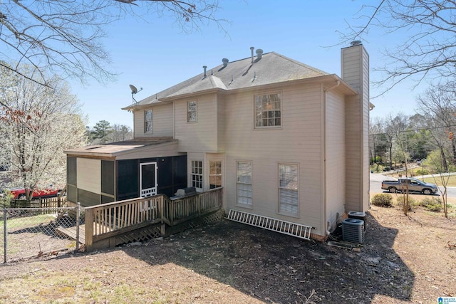 rear view of house with a shingled roof, fence, a wooden deck, central AC, and a chimney