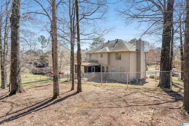 rear view of property with fence private yard and a chimney