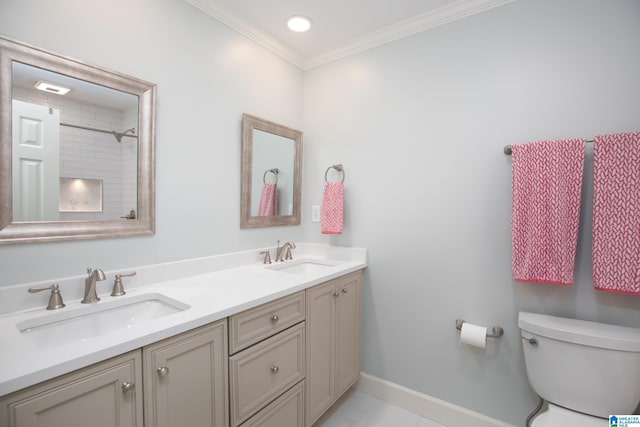 full bathroom with double vanity, ornamental molding, toilet, and a sink