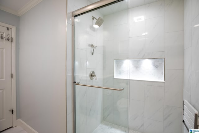 bathroom with crown molding and a shower stall