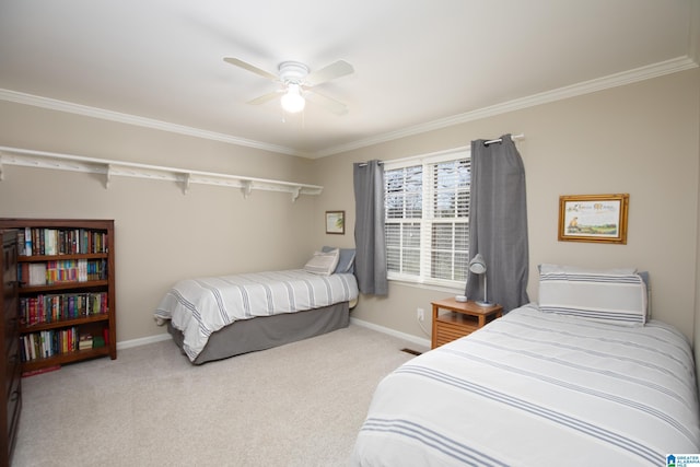 bedroom with crown molding, carpet flooring, baseboards, and ceiling fan