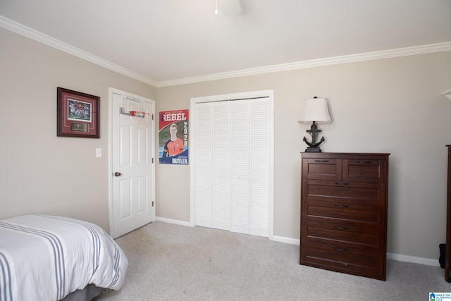 bedroom featuring a closet, ornamental molding, baseboards, and carpet floors